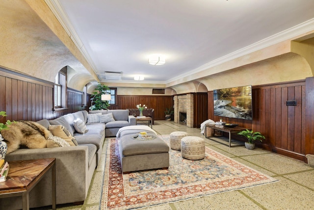 living room with arched walkways, ornamental molding, wooden walls, and speckled floor