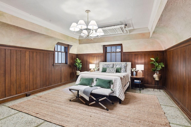 bedroom with an inviting chandelier, wooden walls, and crown molding