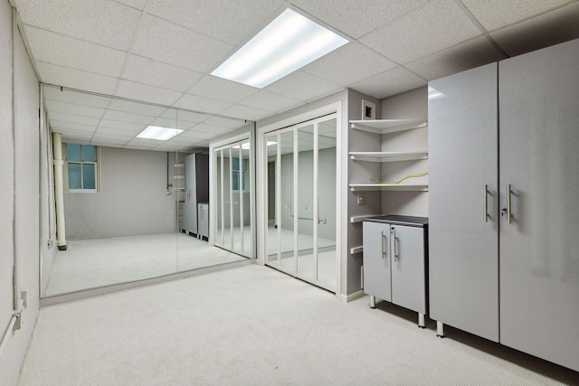 interior space with light carpet and a drop ceiling