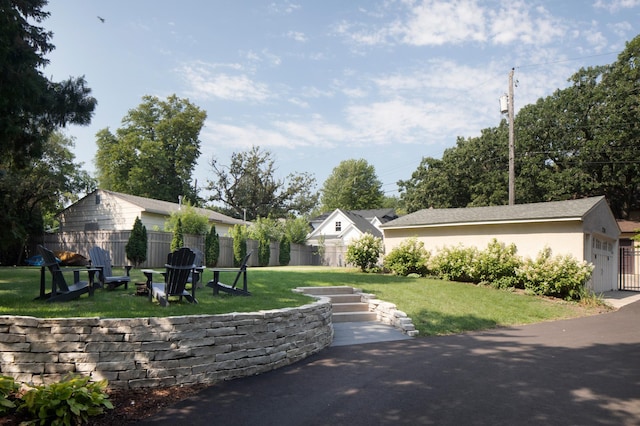exterior space featuring stucco siding, a front lawn, and fence