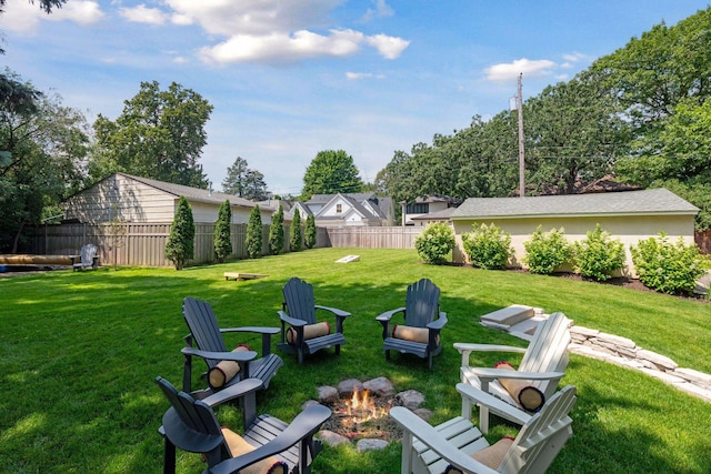 view of yard featuring a fire pit and fence