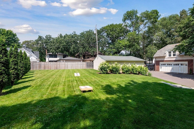 view of yard featuring fence and a garage