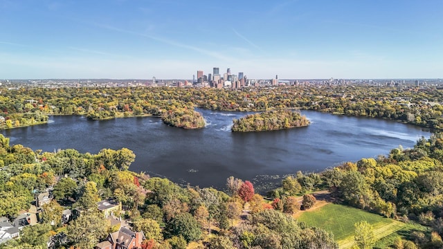 birds eye view of property featuring a water view and a city view