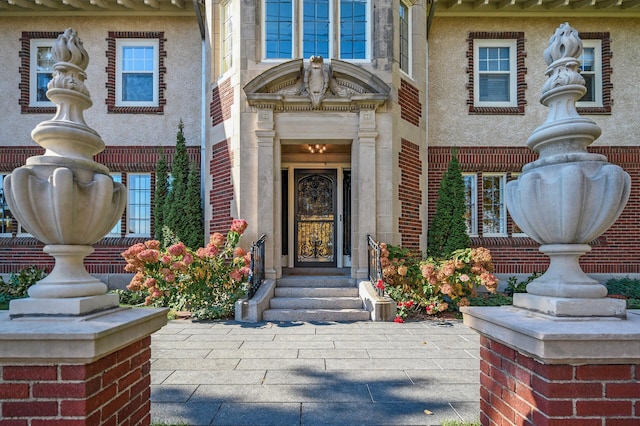 view of exterior entry featuring brick siding