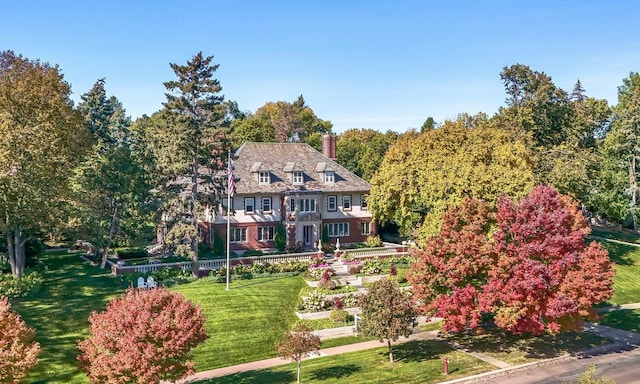 view of front of home featuring a chimney and a front yard