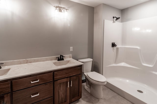 bathroom with vanity, toilet, tile patterned floors, and a shower