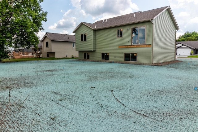 rear view of house with a garage