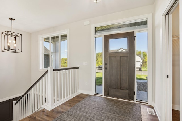 entryway featuring a notable chandelier and dark hardwood / wood-style floors