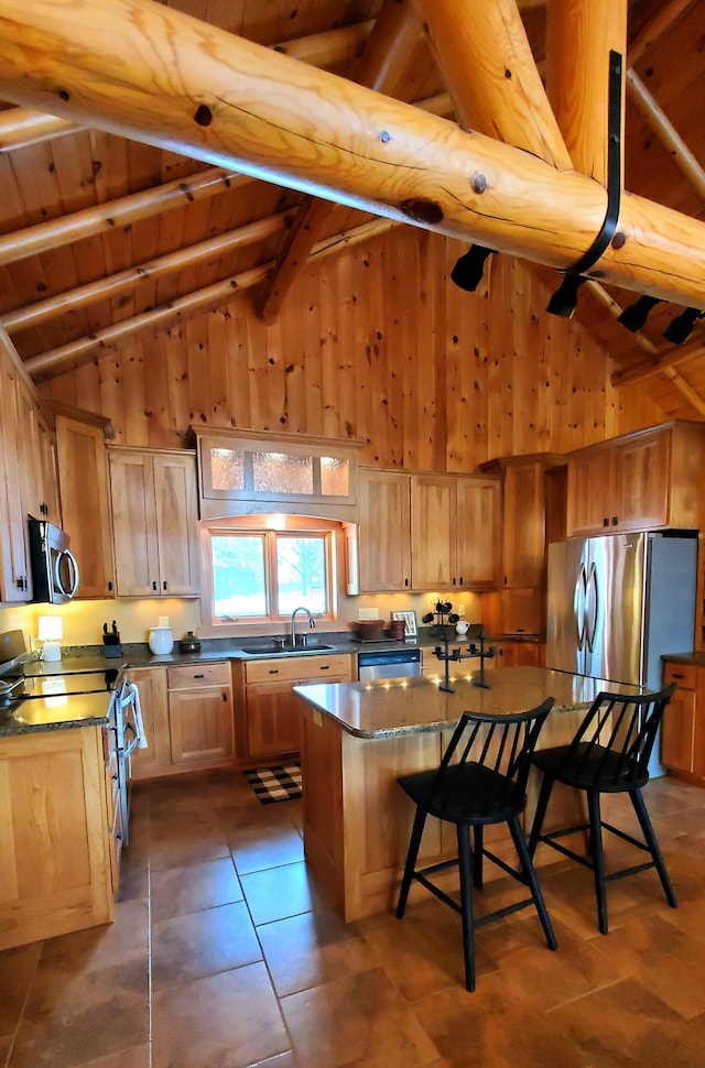 28419 220th St, Shevlin, MN 56676 - kitchen featuring a sink, a center island, appliances with stainless steel finishes, a kitchen bar, and dark countertops