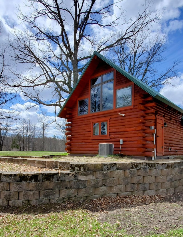28419 220th St, Shevlin, MN 56676 - view of side of home with log siding and central AC unit