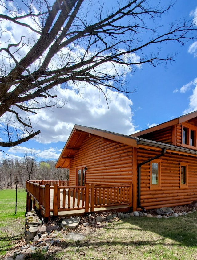 28419 220th St, Shevlin, MN 56676 - view of property exterior with a deck and log siding
