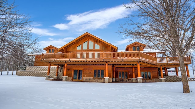 28419 220th St, Shevlin, MN 56676 - snow covered property featuring a wooden deck and stone siding