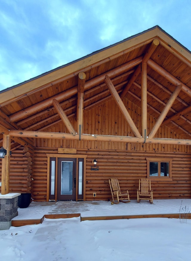 28419 220th St, Shevlin, MN 56676 - snow covered property entrance featuring log exterior