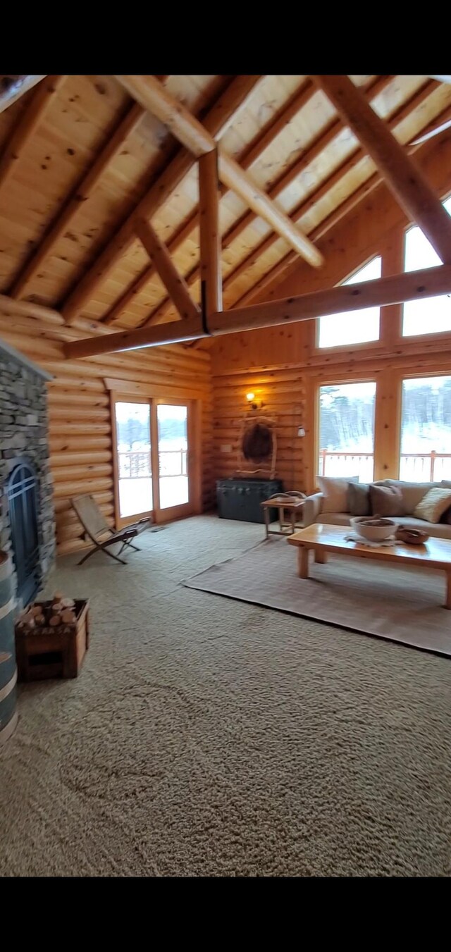 28419 220th St, Shevlin, MN 56676 - carpeted living room with high vaulted ceiling, plenty of natural light, beamed ceiling, and a fireplace