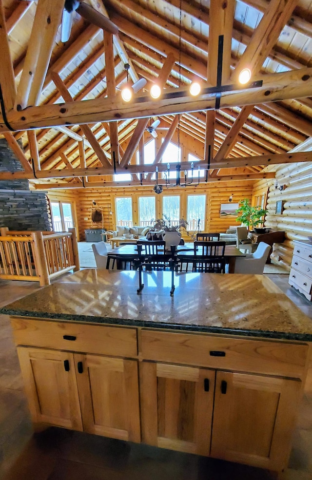 28419 220th St, Shevlin, MN 56676 - kitchen with lofted ceiling, dark stone countertops, and a kitchen island