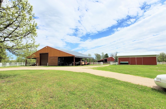 28419 220th St, Shevlin, MN 56676 - view of yard featuring an outbuilding, a detached garage, driveway, and an outdoor structure