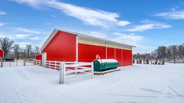 28419 220th St, Shevlin, MN 56676 - snow covered structure featuring a pole building, fence, and an outbuilding