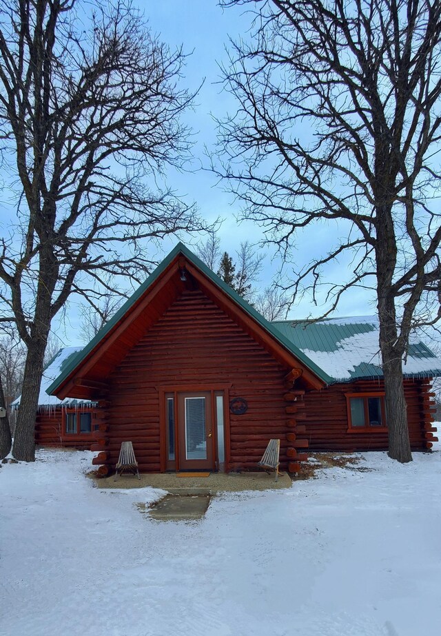 28419 220th St, Shevlin, MN 56676 - snow covered house featuring log exterior and metal roof