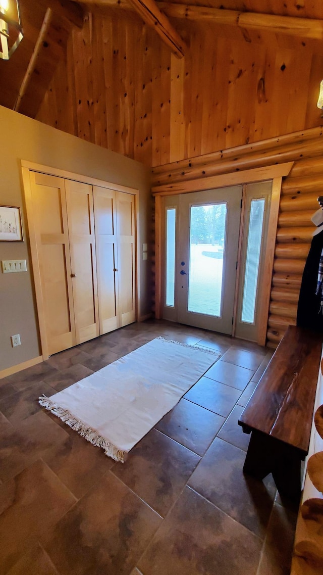 28419 220th St, Shevlin, MN 56676 - foyer entrance featuring high vaulted ceiling, dark tile patterned flooring, and wood walls