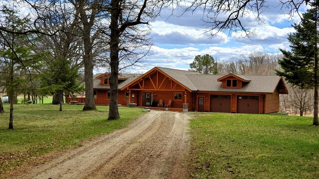 28419 220th St, Shevlin, MN 56676 - log cabin with dirt driveway, log siding, a front yard, and an attached garage
