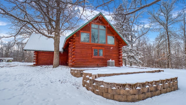 28419 220th St, Shevlin, MN 56676 - snow covered back of property with log exterior and central air condition unit