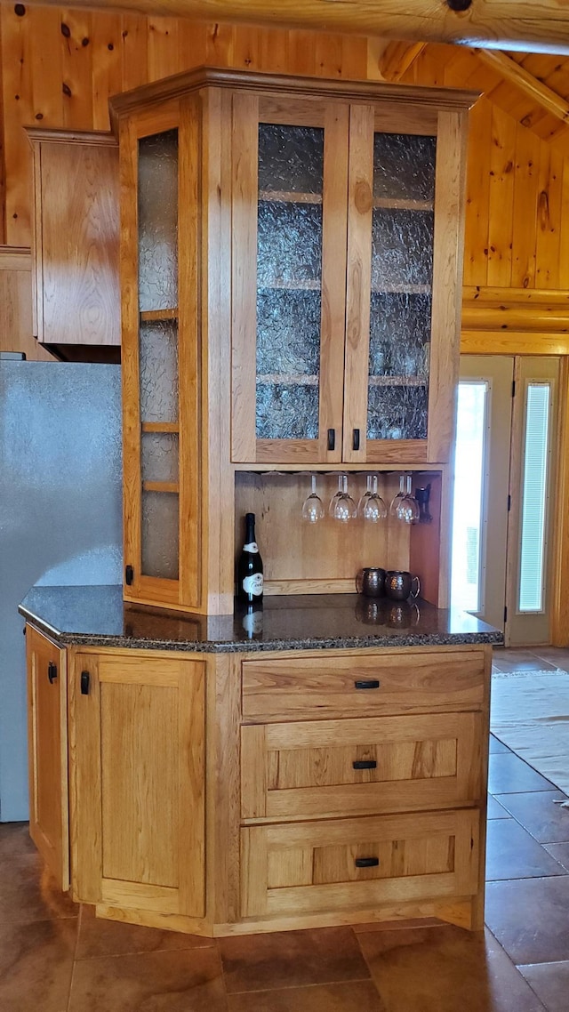 28419 220th St, Shevlin, MN 56676 - indoor dry bar with tile patterned floors, freestanding refrigerator, and wooden walls