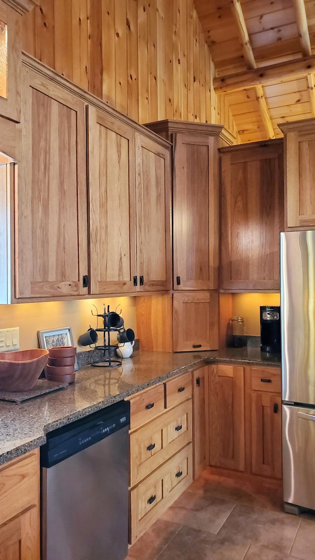 28419 220th St, Shevlin, MN 56676 - kitchen with appliances with stainless steel finishes, wood ceiling, stone countertops, wooden walls, and tile patterned flooring