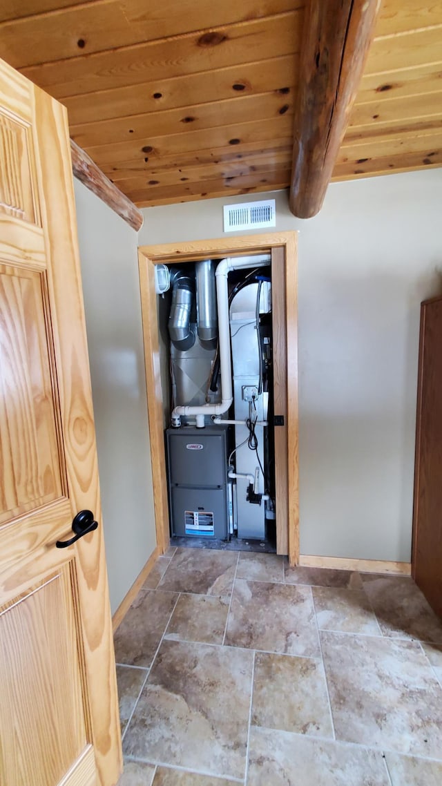 28419 220th St, Shevlin, MN 56676 - hallway with wooden ceiling, baseboards, stone finish floors, and heating unit
