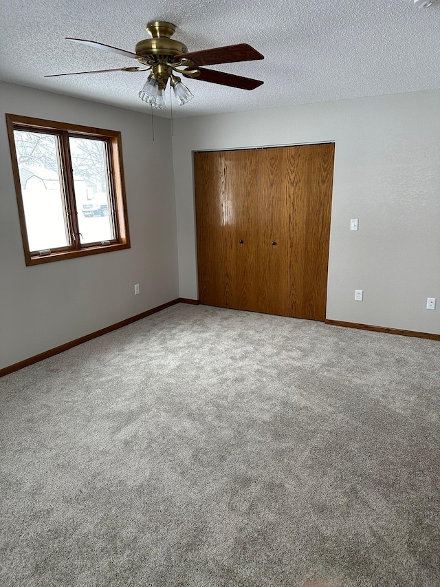 701 Ring Unit 7Th, Canby, MN 56220 - unfurnished bedroom with carpet floors, a textured ceiling, baseboards, and a closet