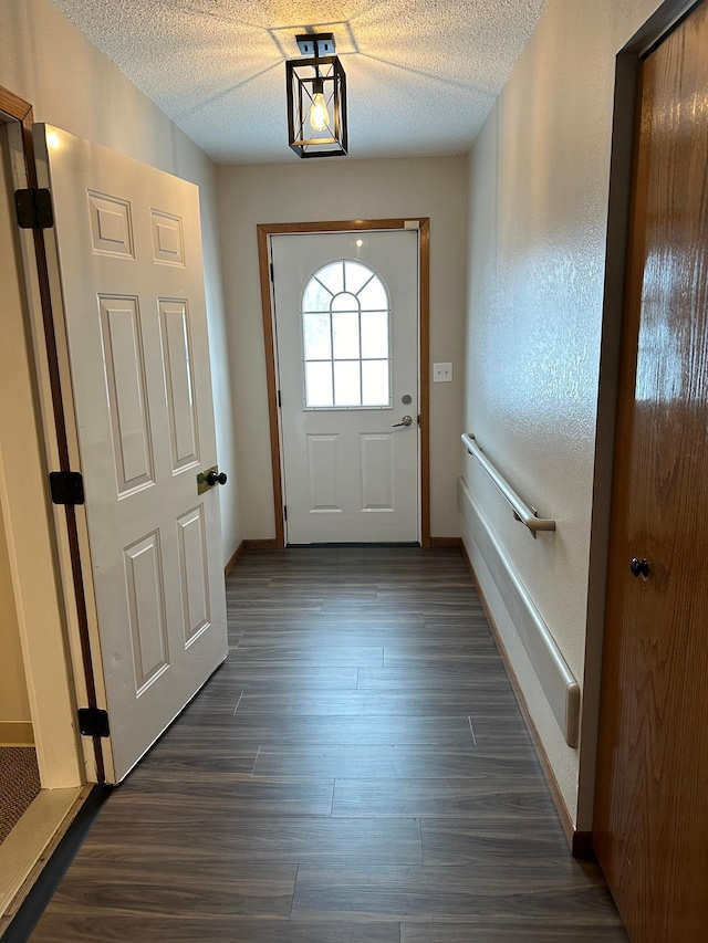 entryway featuring a textured ceiling and dark hardwood / wood-style floors