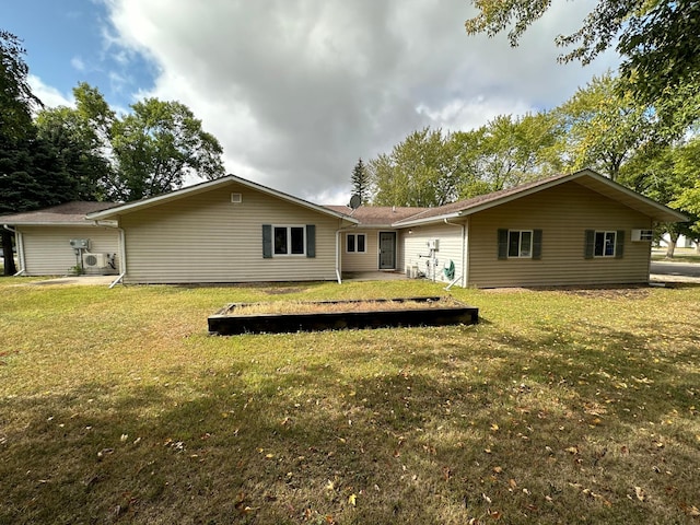 rear view of house featuring a lawn