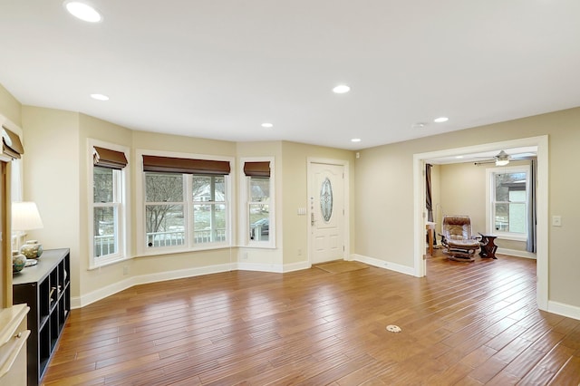 foyer entrance with hardwood / wood-style flooring and ceiling fan