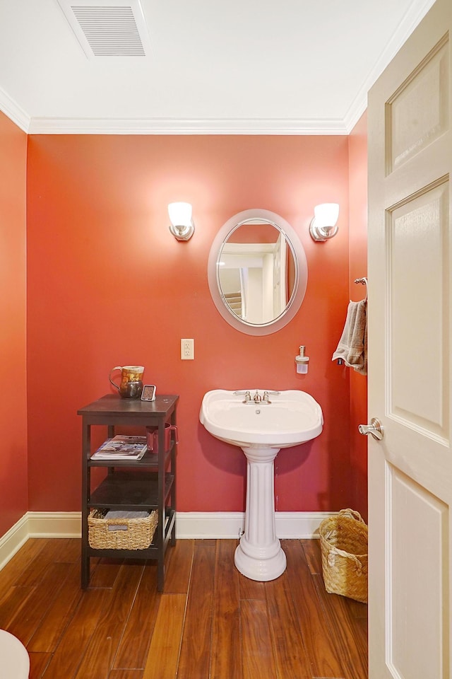 bathroom featuring hardwood / wood-style floors and ornamental molding