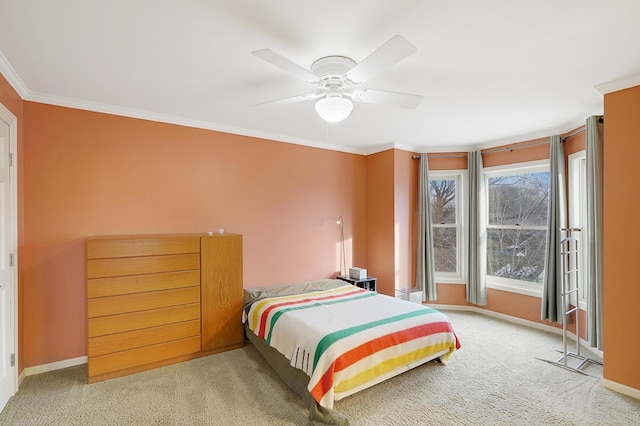 carpeted bedroom featuring ceiling fan and ornamental molding