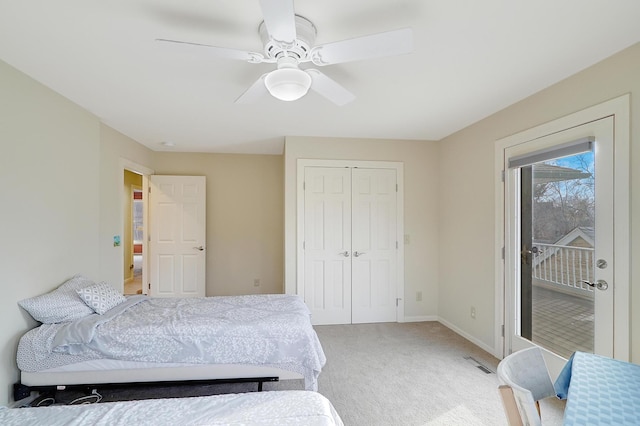 carpeted bedroom featuring a closet, ceiling fan, and access to outside