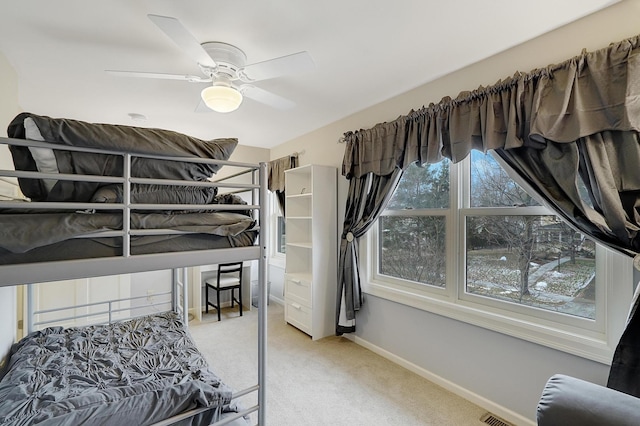 bedroom with ceiling fan and light colored carpet