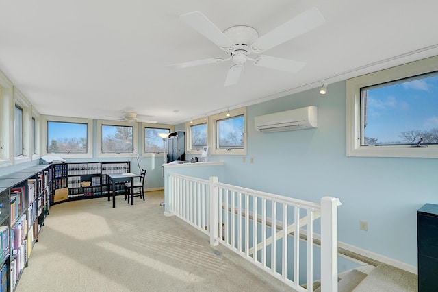 hallway featuring a wall mounted AC, track lighting, and light colored carpet