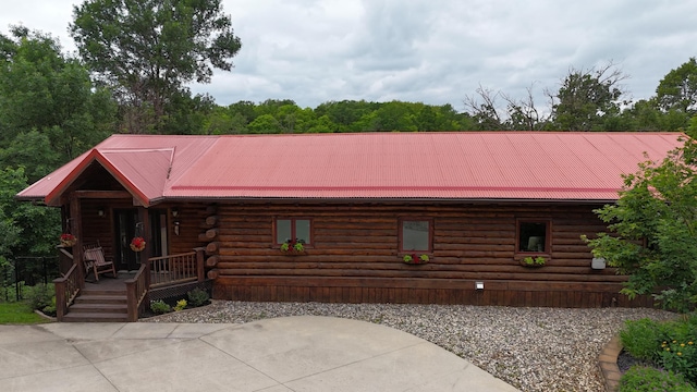 log-style house featuring covered porch