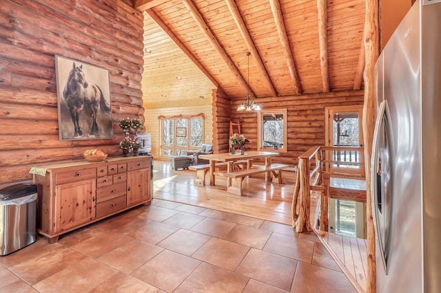 dining space with beamed ceiling, rustic walls, and high vaulted ceiling