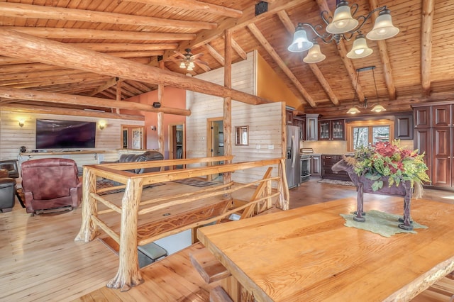 dining area with beamed ceiling, wooden ceiling, and light hardwood / wood-style flooring