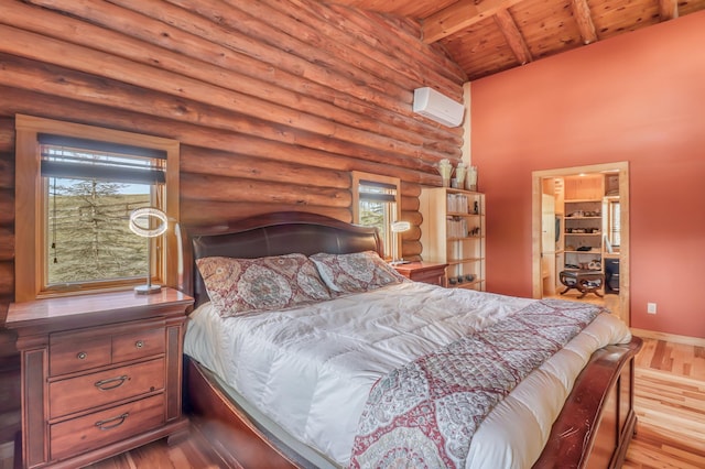 bedroom with a wall mounted air conditioner, light wood-type flooring, wood ceiling, log walls, and beam ceiling