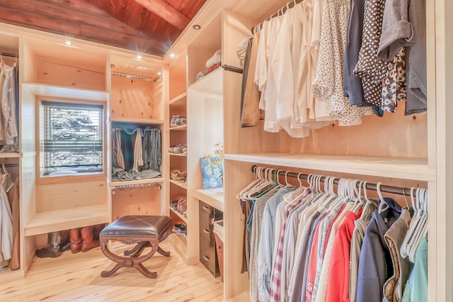 spacious closet featuring beamed ceiling and light hardwood / wood-style floors