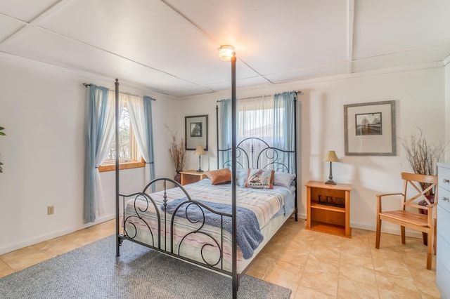 tiled bedroom featuring multiple windows