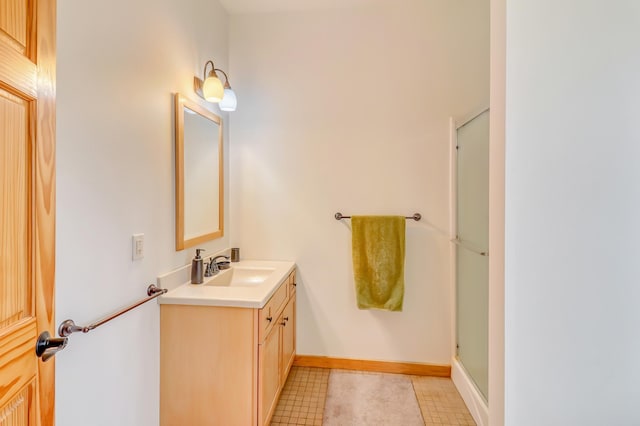 bathroom featuring vanity and an enclosed shower