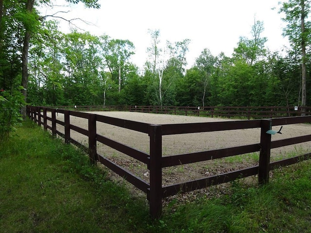 view of gate with a rural view