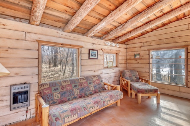 living area with vaulted ceiling with beams, wooden ceiling, and heating unit