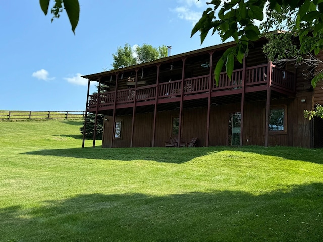 back of property featuring a yard and a deck