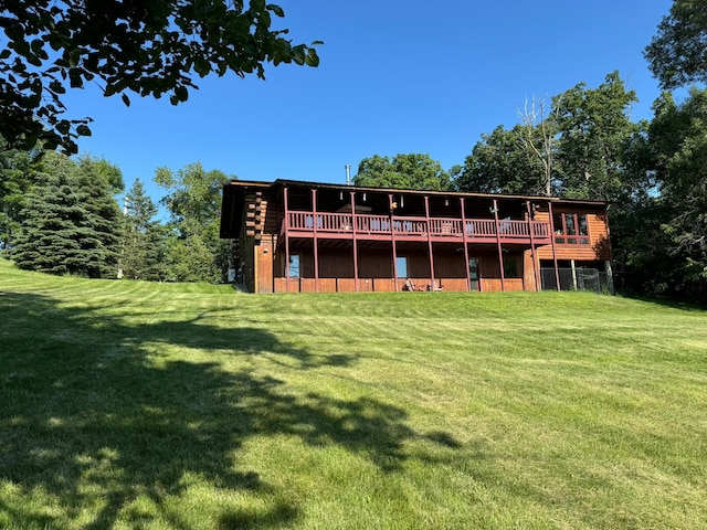 rear view of house with a deck and a lawn