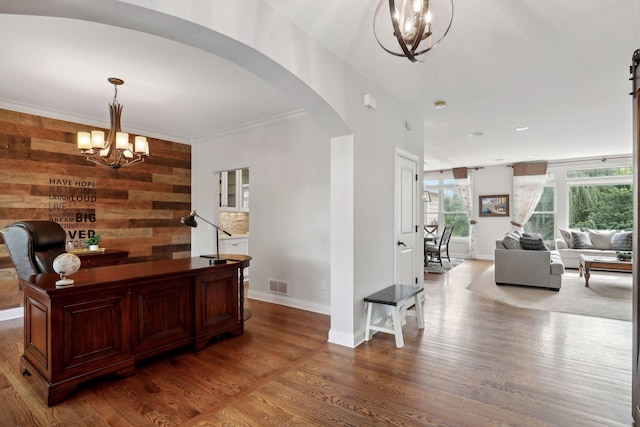 office featuring a chandelier, arched walkways, visible vents, and wood finished floors