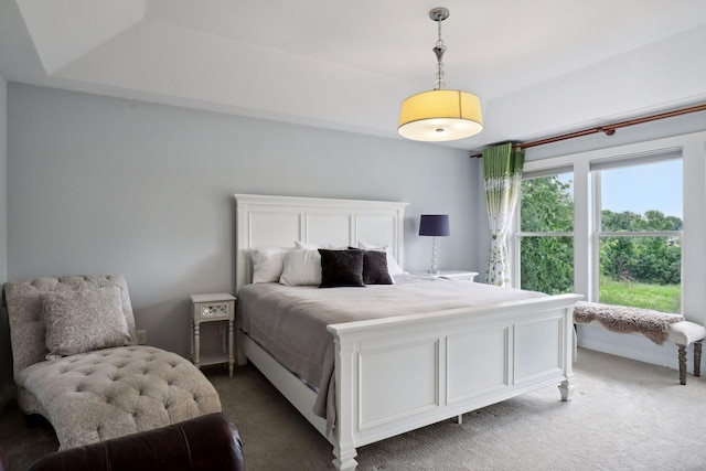 bedroom featuring baseboards and dark carpet